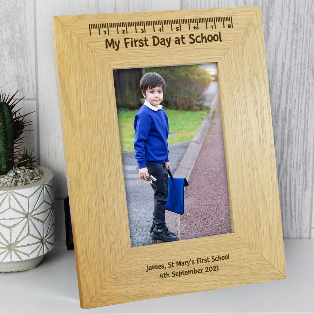 Wooden photo frame with a child's first day at school picture, engraved with details.