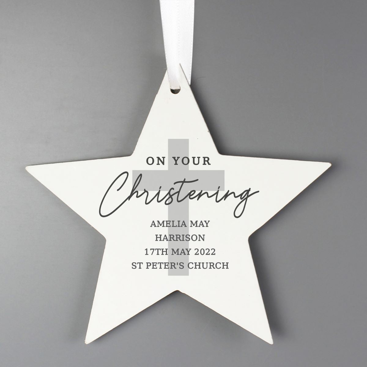 White star-shaped ornament with text on a gray background