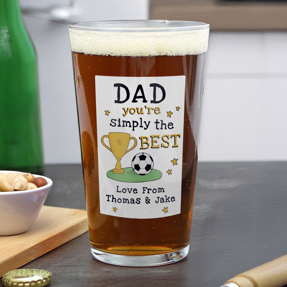 Pint glass with a personalized label for Dad on a kitchen counter.