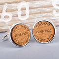 A pair of round silver cufflinks with engraved light brown wooden faces. One cufflink is engraved with 'TODAY I MARRY MY BEST FRIEND' and a date in the middle the other 'GROOM I LOVE YOU' and the same date.