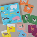 Children's memory educational card game with animal illustrations on a beige surface