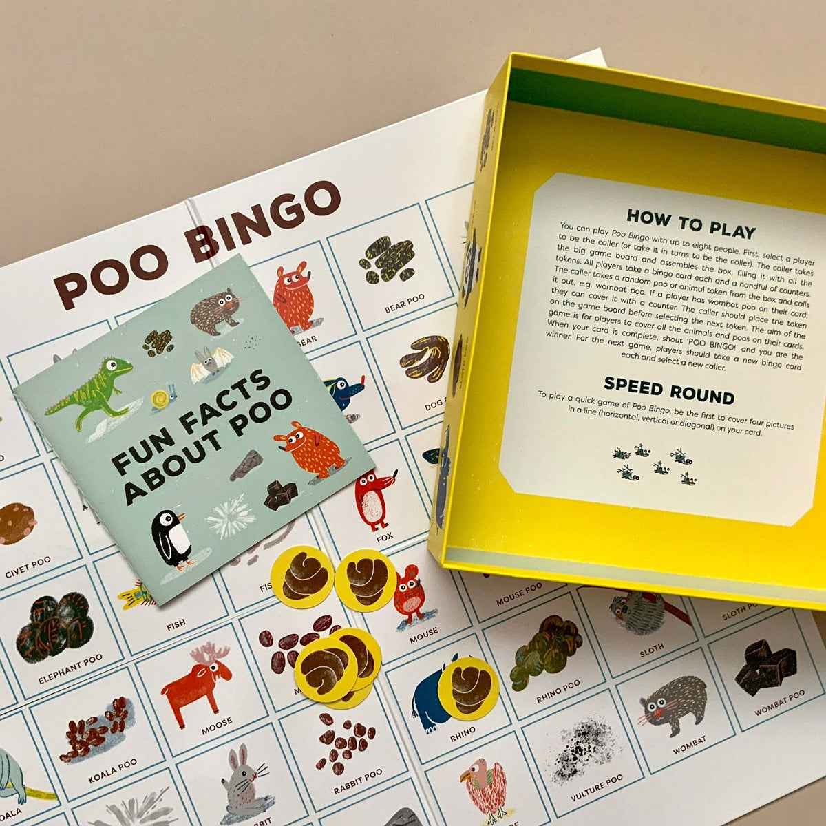 Poo Bingo game with cards and instructions on a beige surface