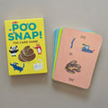 The card game 'Poo Snap!' shown with its bright yellow box and a fan of illustrated cards on a neutral grey background.