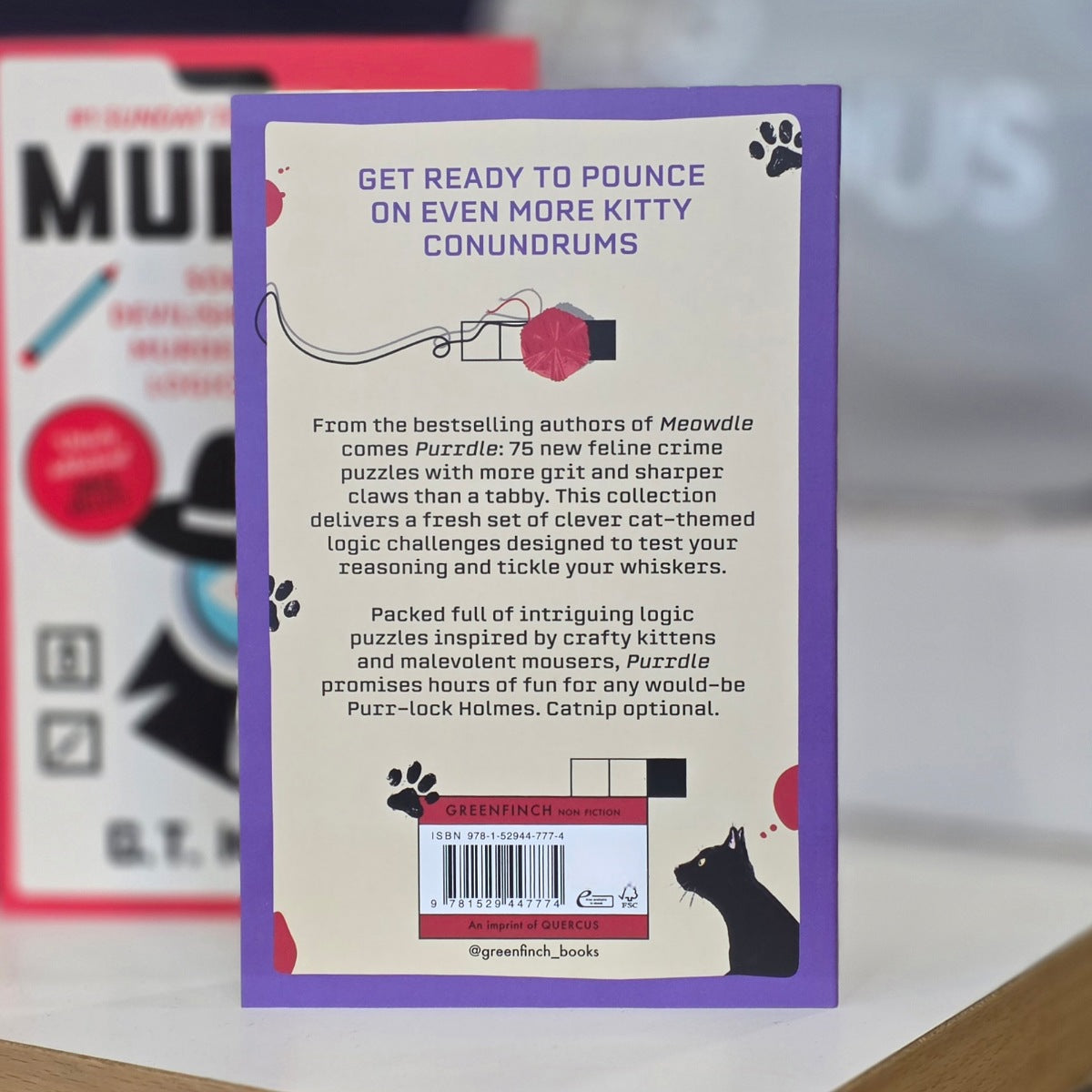 Back book cover with words 'get ready to pounce on even more kitty conundrums'
