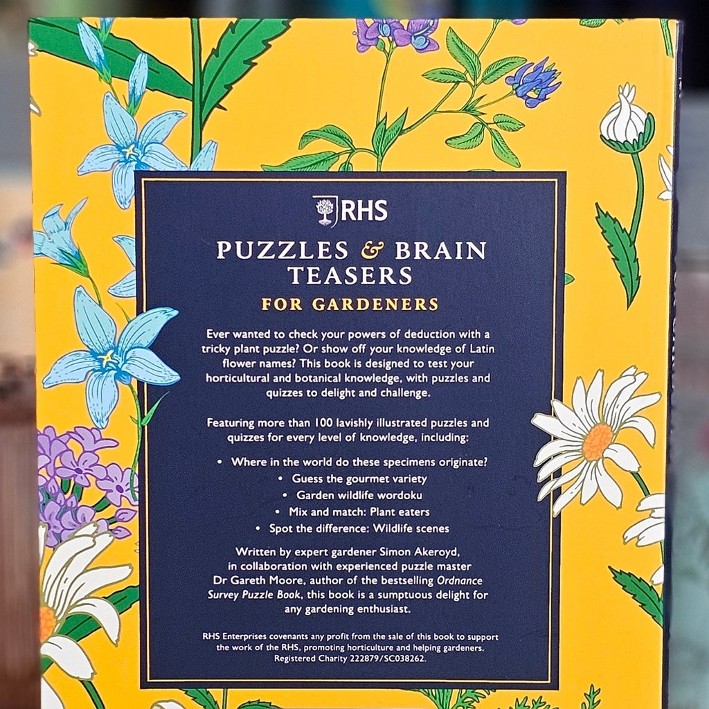 Book cover of 'RHS Puzzles & Brain Teasers for Gardeners' with floral design