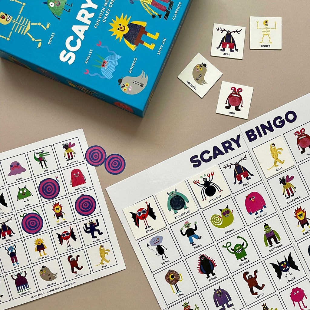 Scary Bingo board game with monster illustration cards and a blue box on a beige surface