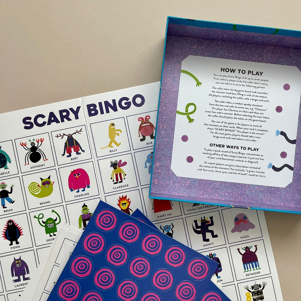 Scary Bingo game set with cards and instructions on a beige surface