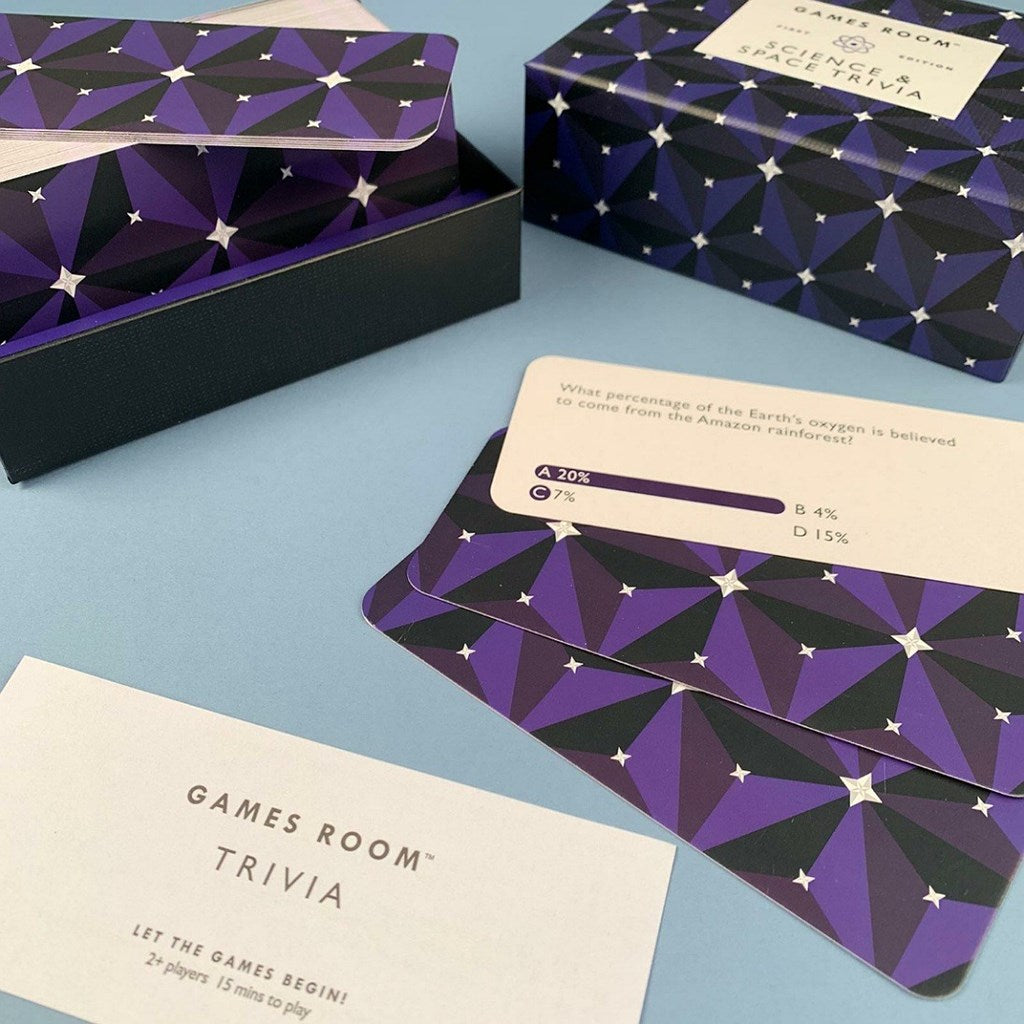 Games Room Trivia card game set with purple geometric patterned cards, matching boxes, and a blue background.