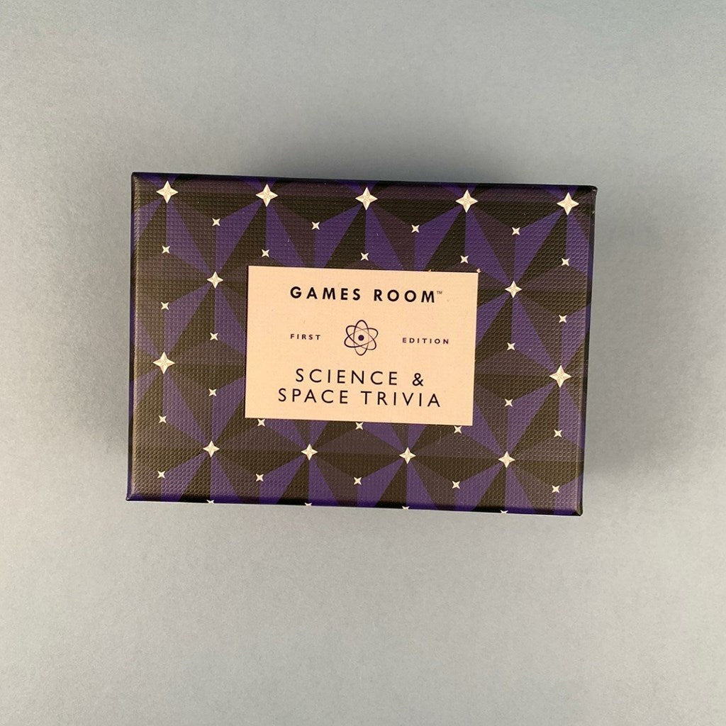 Games Room First Edition 'Science & Space Trivia' game box, featuring a dark purple and black geometric pattern with white stars and a beige label in the center, set against a plain gray background.