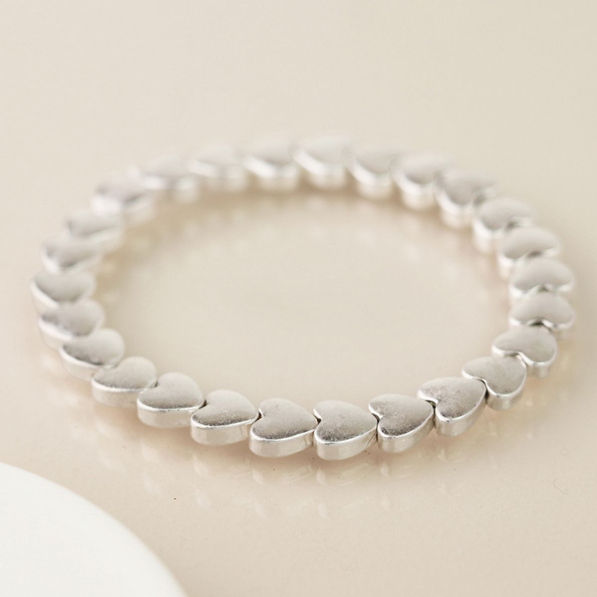 Silver bracelet on a beige background