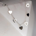 Silver heart-shaped bracelet on a light background