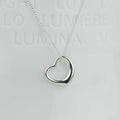 A silver open heart pendant necklace on a delicate silver chain, displayed against a light gray background with faint embossed text.