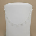 A delicate silver chain necklace with multiple small, circular, textured disc charms draped over a white display bust against a solid beige background.