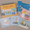A children's jigsaw puzzle set titled 'STORY BOX' arranged on a neutral beige surface. The set includes a colourful illustrated box and several puzzle pieces showing animal adventure scenes on the ocean.