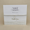 Bracelet on a 'nest' branded card with 'Thank You' text on a beige background