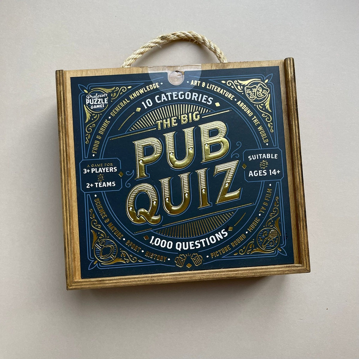 Wooden box with rope handle titled 'The Big Pub Quiz' on a light  background