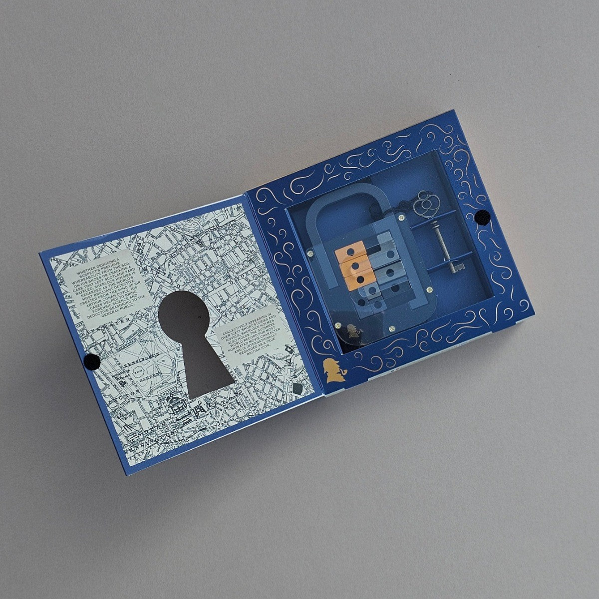 Open blue box with transparent mechanical lock and key on a grey background
