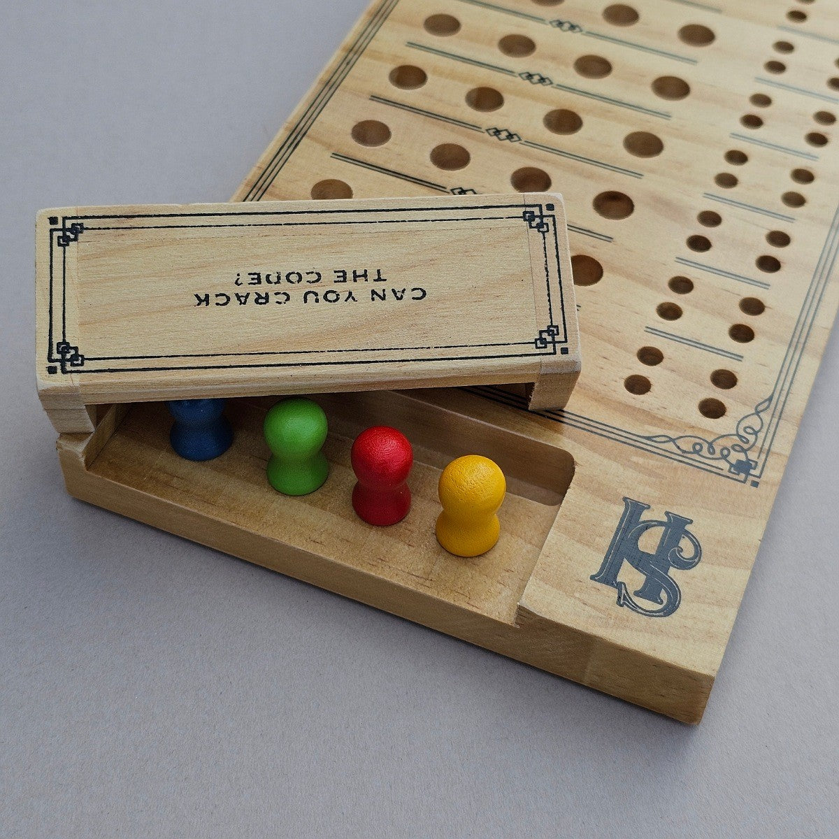 Wooden game board with pegs and text on a grey background