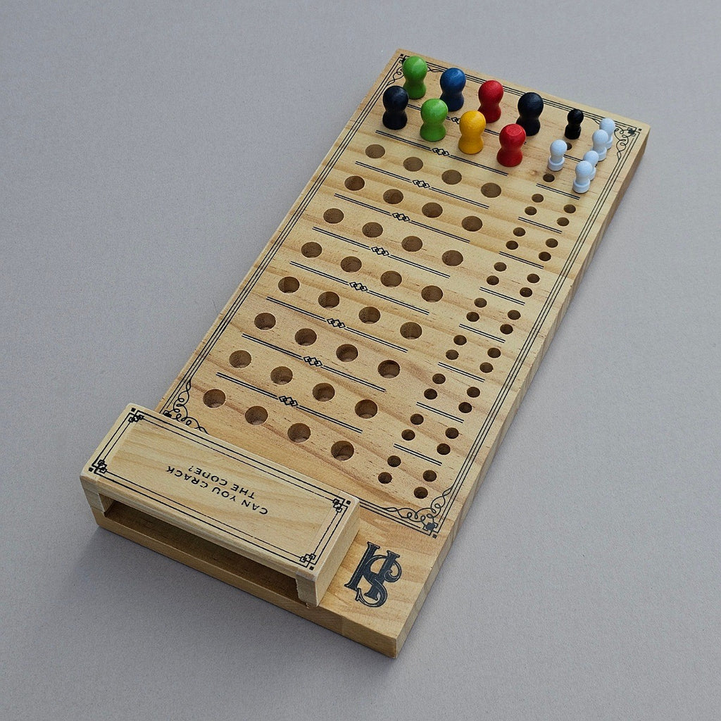 Wooden cribbage board with pegs on a grey background