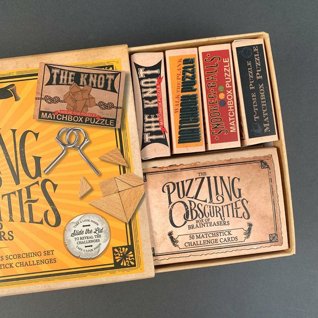 Matchbox puzzle set with various matchbooks and a card on a grey background